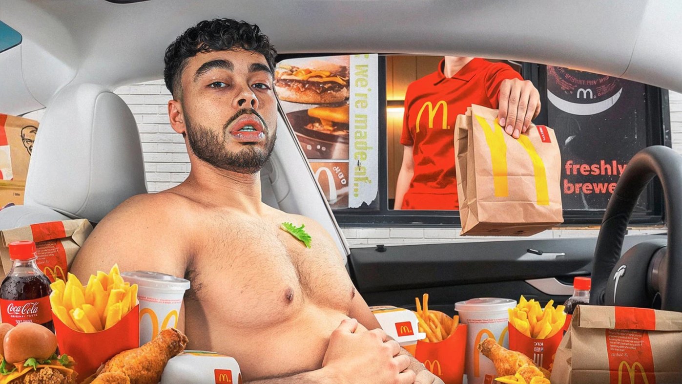 Man in a car loaded with McDonald's at the drive-thru